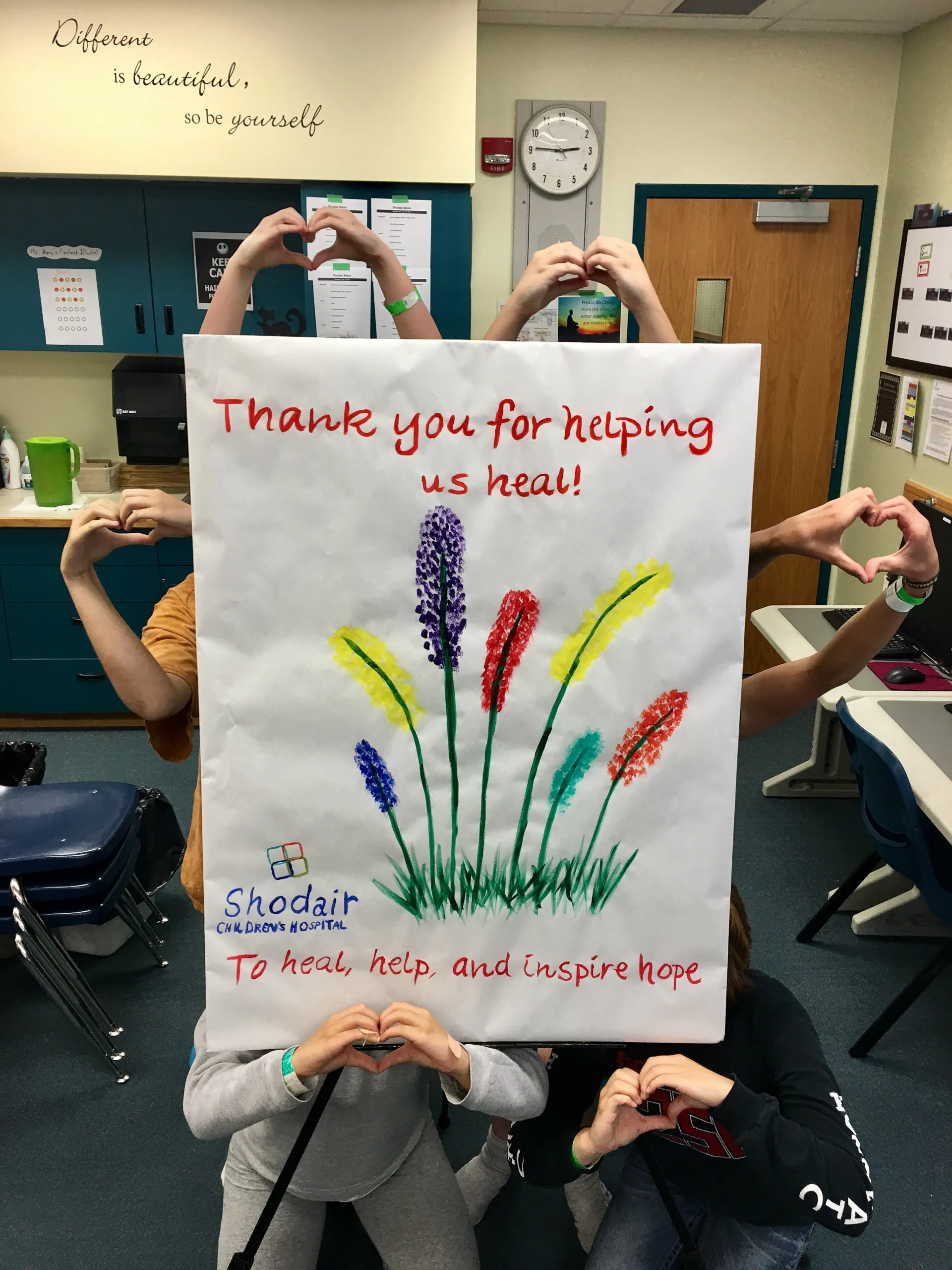 photo of a group of people holding up a sign thanking donors to Shodair